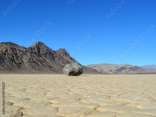 one rock leaving a long trail marks the path of one of the mysterious moving rocks on Death Valley Racetrack Playa, California