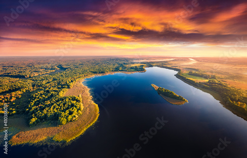 Aerial landscape photography. Awesome summer sunset on Krymne Lake. Dramatic evening view from flying drone of Shatsky National Park, Volyn region, Ukraine. Beauty of nature concept background.