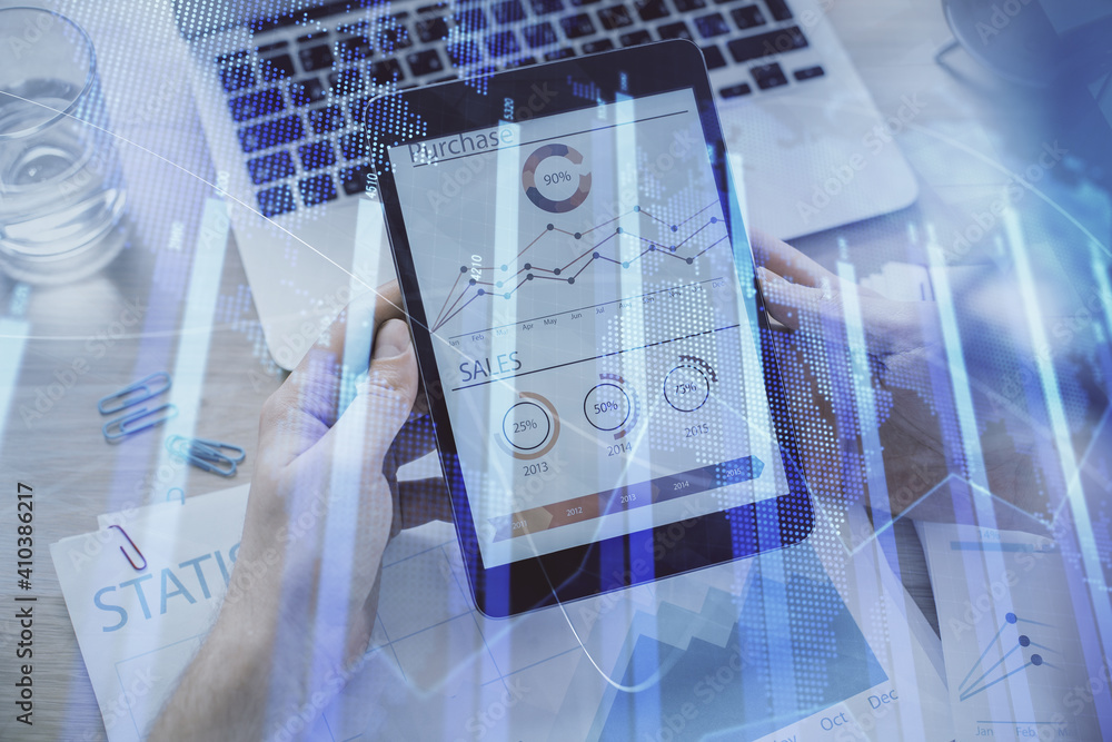 Double exposure of man's hands holding and using a digital device and forex graph drawing. Financial market concept. Double exposure of man's hands holding and using a digital device and forex graph drawing. Financial market concept.