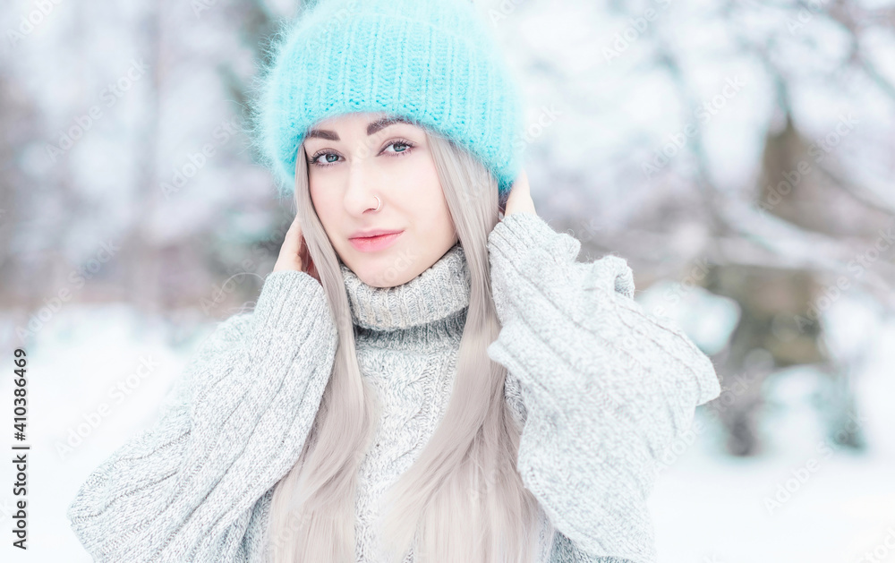 Close up photo of  young woman European appearance in blue hat with beautiful eyes and ring in the nose