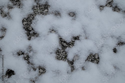 snow covered pavement with gravel © KyriaKos Kinatidis