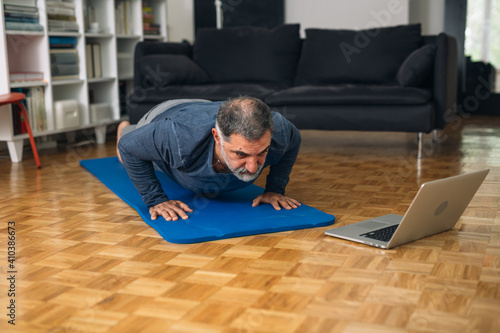 middle aged man training in his home