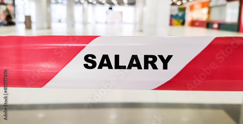 SALARY word on red ribbon indoors during the day
