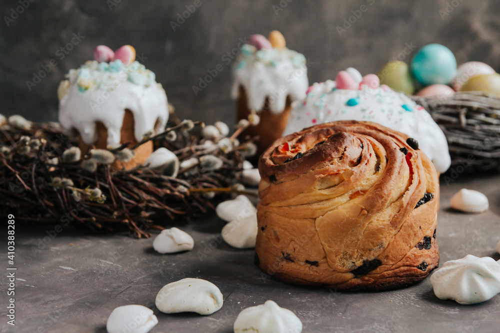 Easter cakes with white cream and painted Easter eggs on a dark gray background. Easter cakes with white cream and painted Easter eggs on a dark gray background.