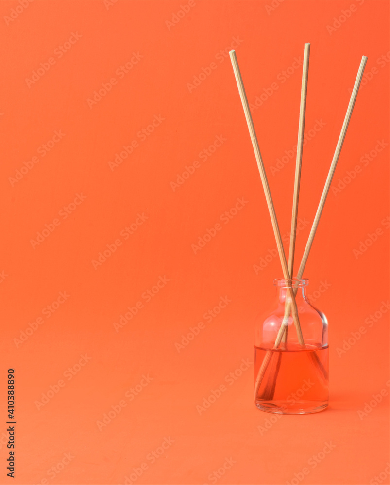 Small glass container, mild air freshener, shades of orange. Copy space. Small glass container, mild air freshener, shades of orange. Copy space.