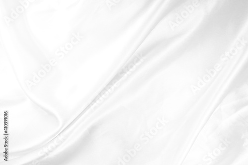 White fabric is satin or silk abstract background which has wrinkles that are very smooth and clean with soft wave design