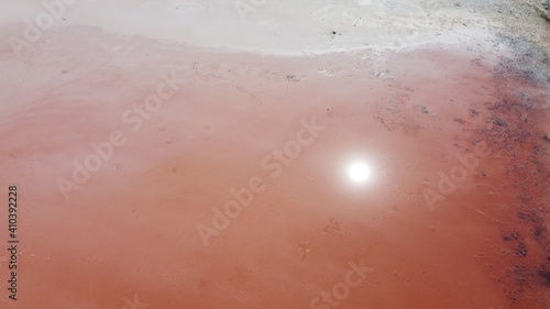 Aerial top view of beautiful salt lake with pink water. View of pink lake from flying drone. Drone copter photography from above
