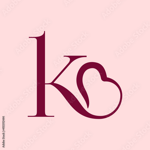 Letter k logo.Wedding decorative creative typographic icon isolated on pink fund.Ornate symbol for gift boutique brand.Lowercase alphabet initial.Heart outline playful element.Red color.