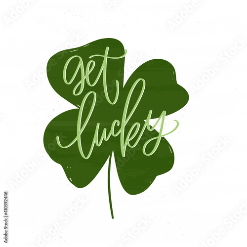 Get lucky hand lettering saying for St. Patrick’s day decoration. Vector four-leaf clover clipart with wishing of good luck and fortune.
