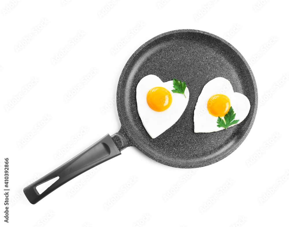 Romantic breakfast with fried heart shaped eggs isolated on white, top view. Valentine's day celebration Romantic breakfast with fried heart shaped eggs isolated on white, top view. Valentine's day celebration