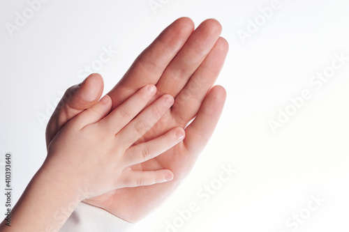 Child hand in parent palm