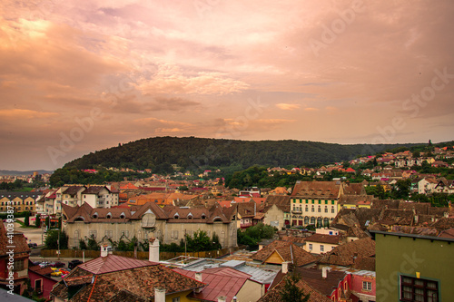 Sunset over the colorful city with medieval buildings