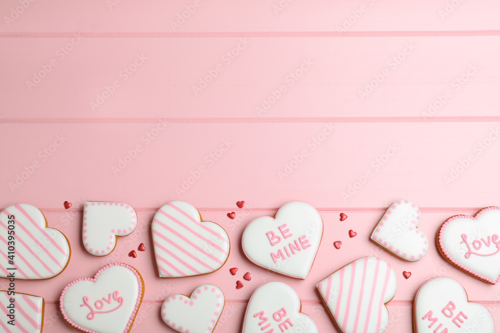 Valentine's day cookies on pink table, flat lay. Space for text