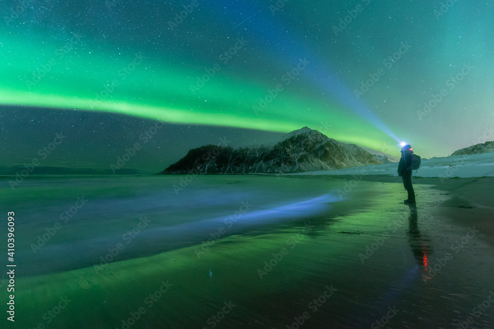 Man looking at Aurora Borealis lights.