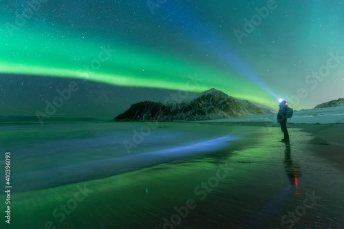 Man looking at Aurora Borealis lights.