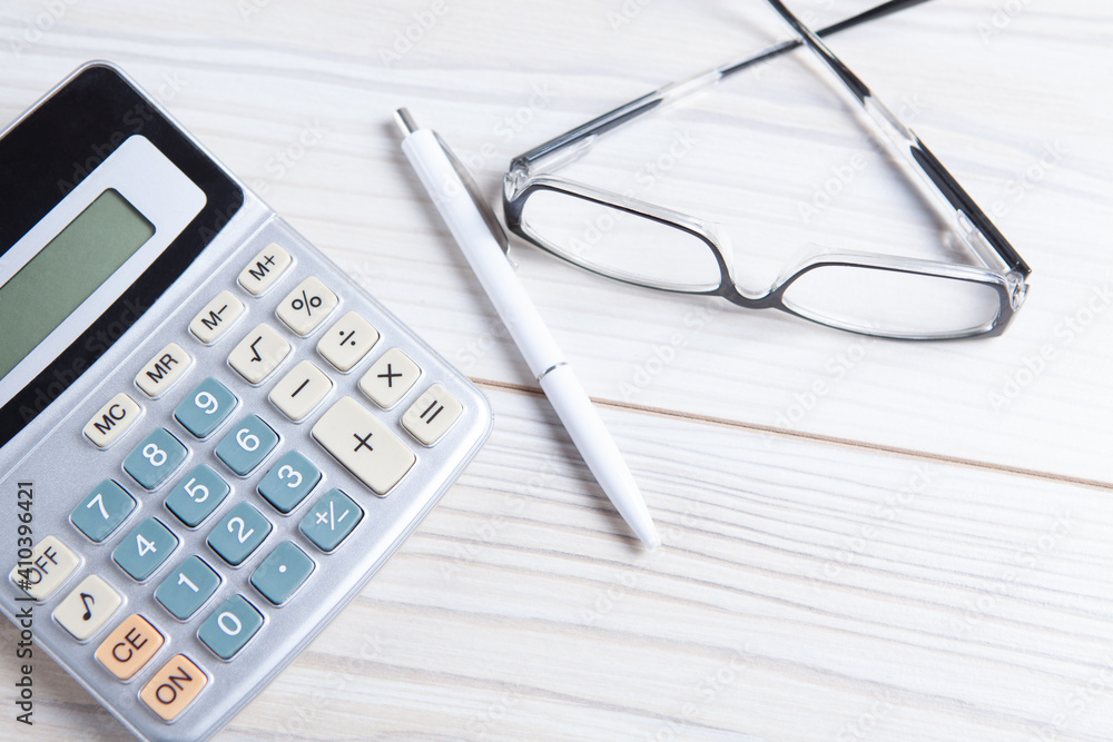 Close up calculator and financial report - accounting concept Close up calculator and financial report - accounting concept