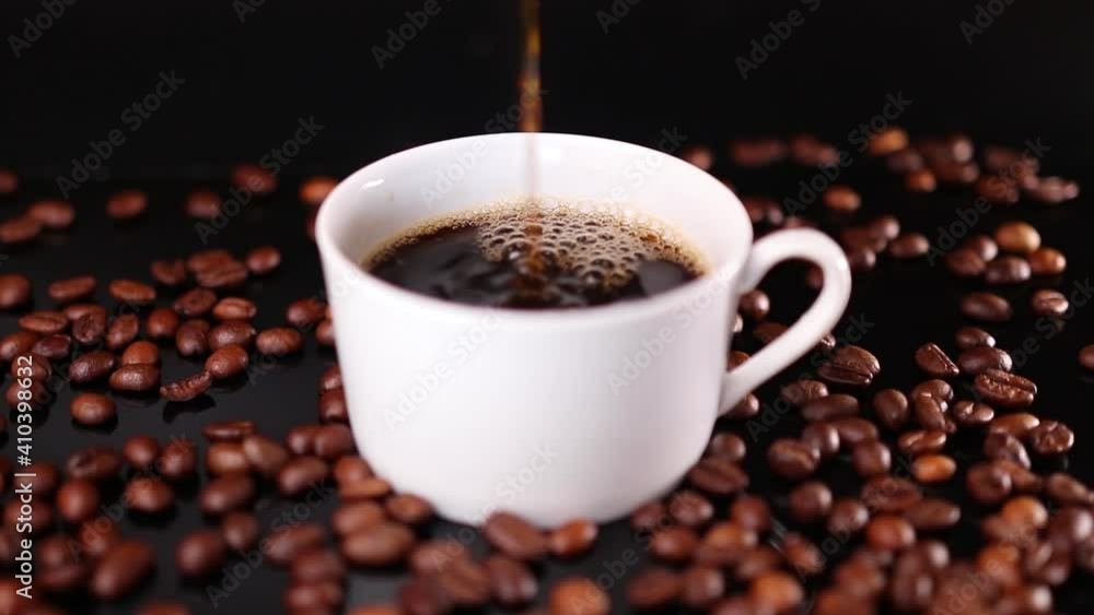 Coffee flowing in white cup with roasted beans around Coffee flowing in white cup with roasted beans around