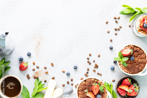The recipe for an Italian dessert Tiramisu, with all the necessary ingredients of an amine against a white background. Copy top view