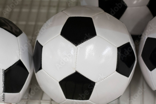Black and white soccer ball on a shelf in the sports department of a supermarket