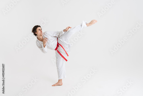 Young caucasian sportsman dressed in kimono practice in karate