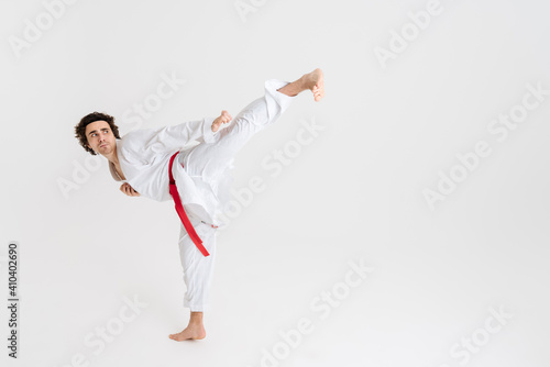 Young caucasian sportsman dressed in kimono practice in karate