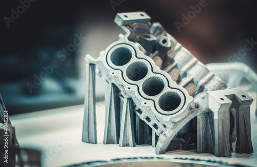 Man is holding object printed on metal 3d printer. photo