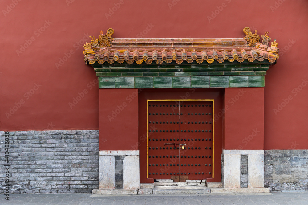 Red Chinese traditional style wooden door on brick wall Red Chinese traditional style wooden door on brick wall