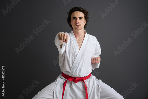 Young caucasian sportsman dressed in kimono practice in karate