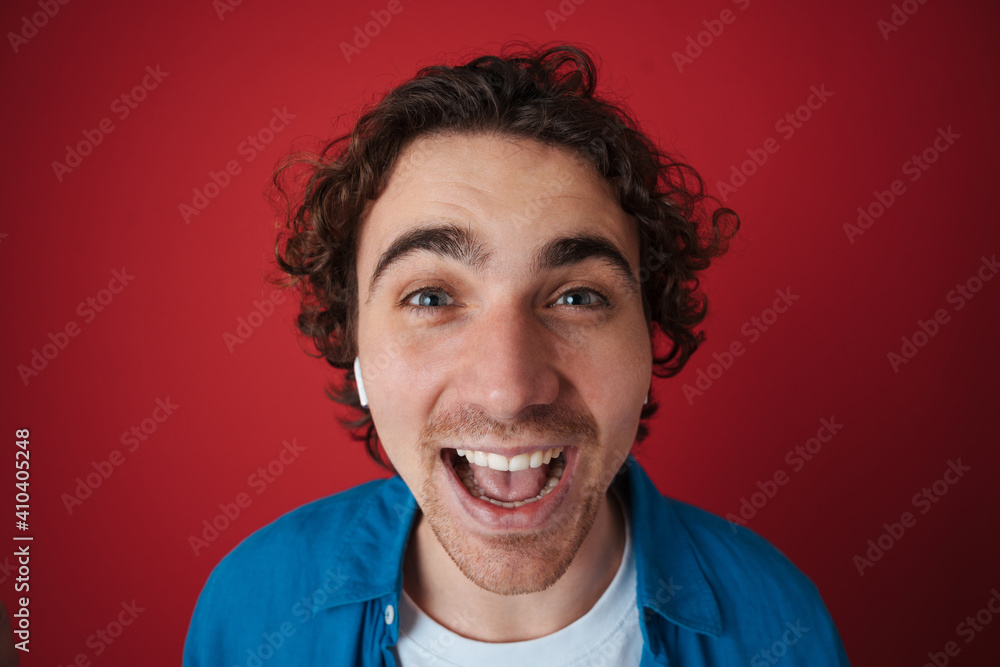 Excited handsome man posing and laughing at camera Excited handsome man posing and laughing at camera