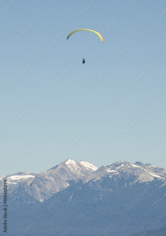paraglider flying over the Andes mountain range, near Deariloche