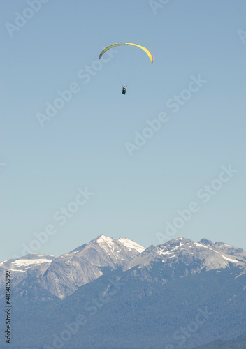paraglider flying over the Andes mountain range, near Deariloche