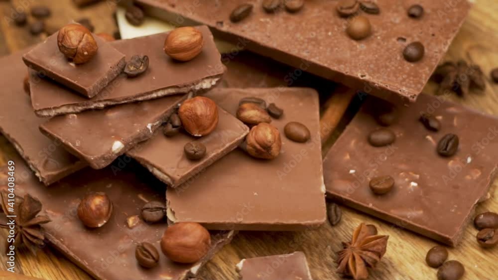 Sweet Natural Chocolate Pieces with Nuts and Coffee, Chocolate Bars, Isolated, Close-up. Background of Pieces of Chocolate and Chocolate Bars. Sweet Natural Chocolate Pieces with Nuts and Coffee, Chocolate Bars, Isolated, Close-up. Background of Pieces of Chocolate and Chocolate Bars.