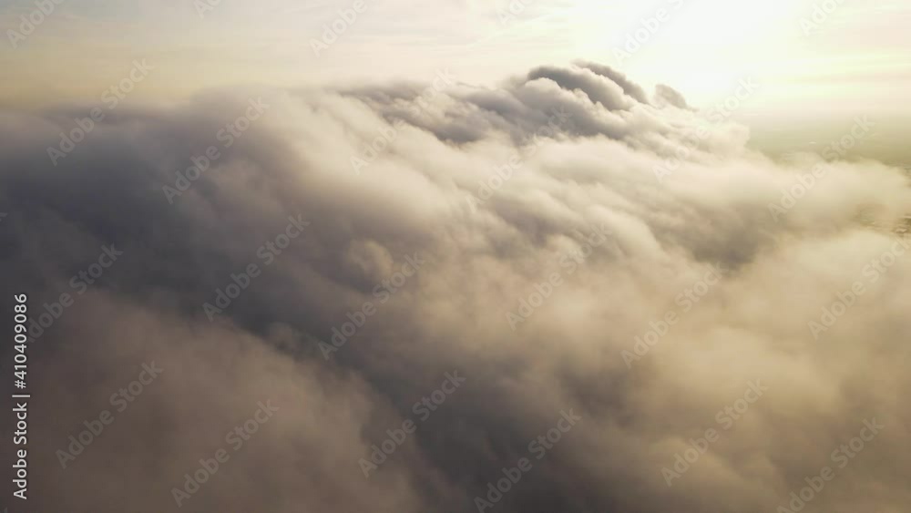 It's going through the clouds. The camera moves forward through thick smoke