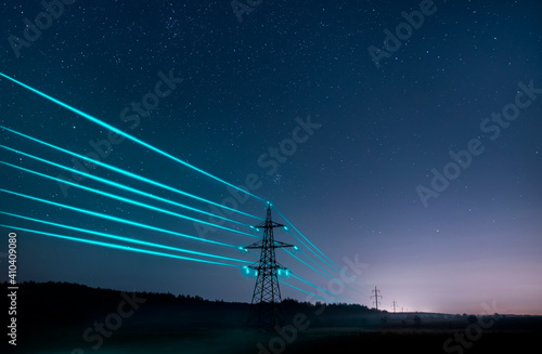Fotografiet Electricity transmission towers with glowing wires against the starry sky