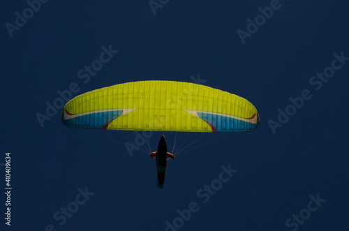 paraglider seen from below with deep blue sky in the background