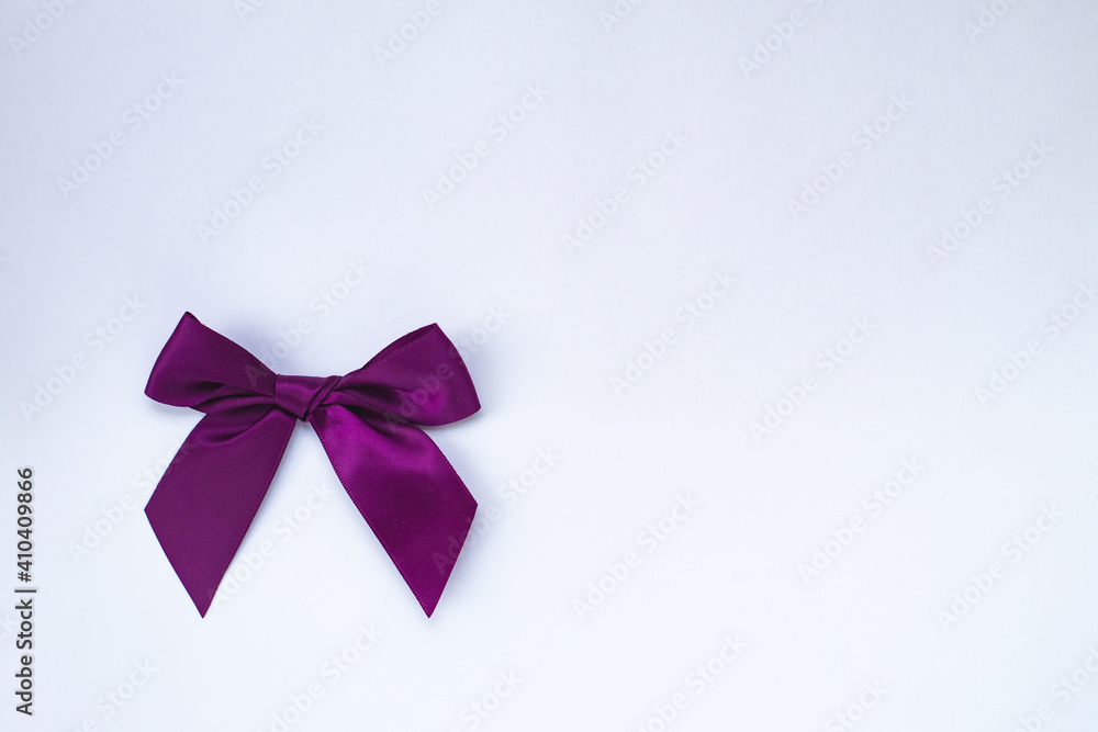 Top view(flat spoon) of a purple bow isolated on a white background. copy the space.