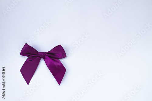 Top view(flat spoon) of a purple bow isolated on a white background. copy the space.