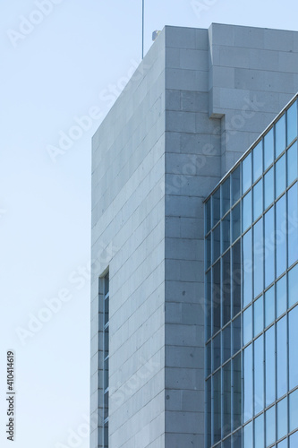 Close-up of an anonymous office building in Madrid, Spain, under the scorching summer sun. A closed work space, sterile for life and built with concrete, steel and glass.
