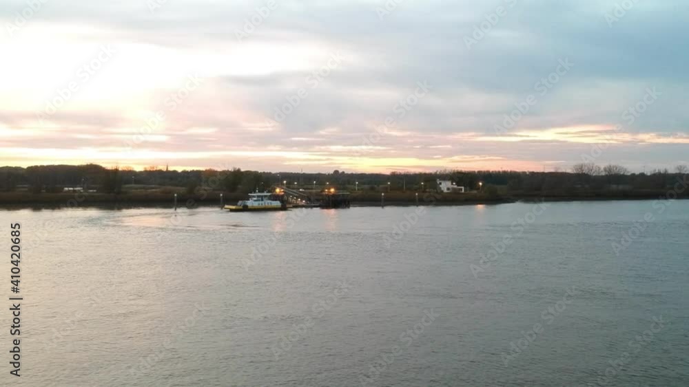 Small ferry boat is docking on other side of river for people transportation Small ferry boat is docking on other side of river for people transportation