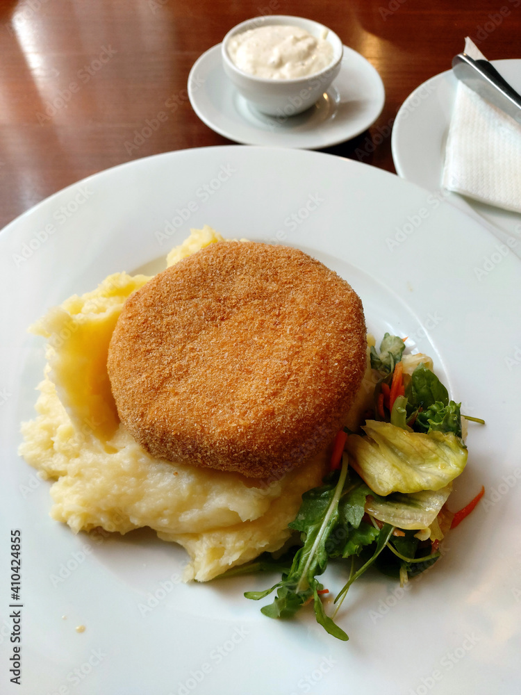 Fried breaded cheese and mashed potatoes gourmet lunch. 