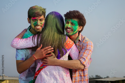 A GROUP OF FRIENDS WISHING EACH OTHER ON THE OCCASION OF HOLI 