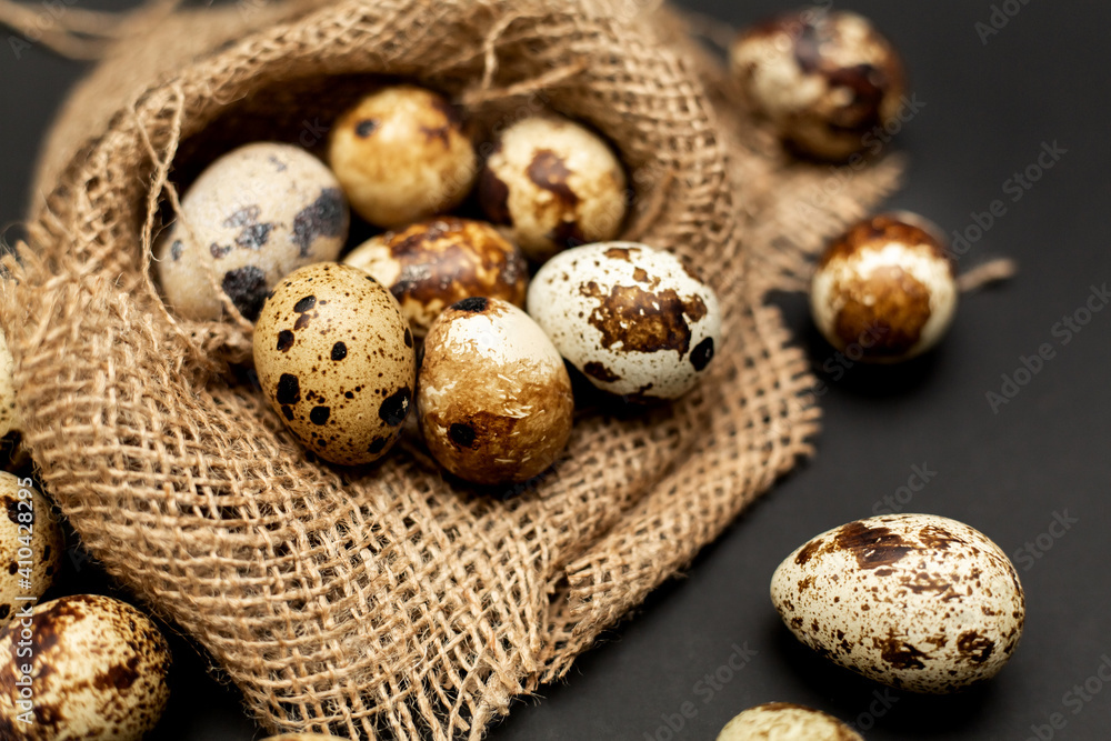 Quail eggs, isolated on a sack. Black background Quail eggs, isolated on a sack. Black background