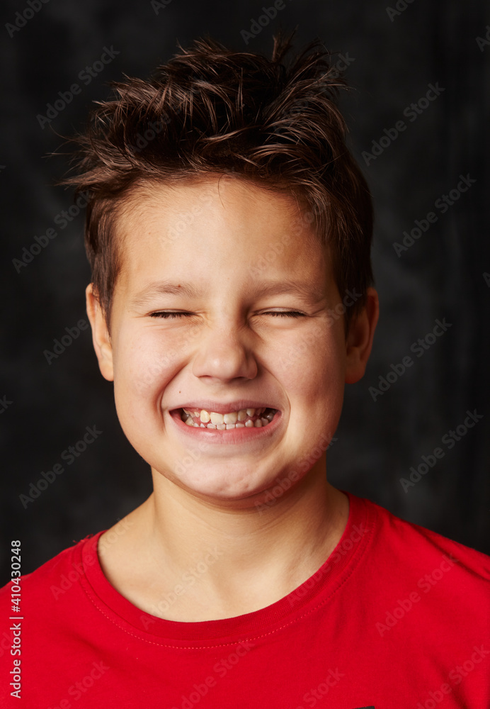 European school boy laughs straight at the camera, European school boy laughs straight at the camera,