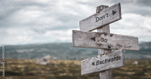 Photos dont go backwards text engraved on wooden signpost outdoors in nature
