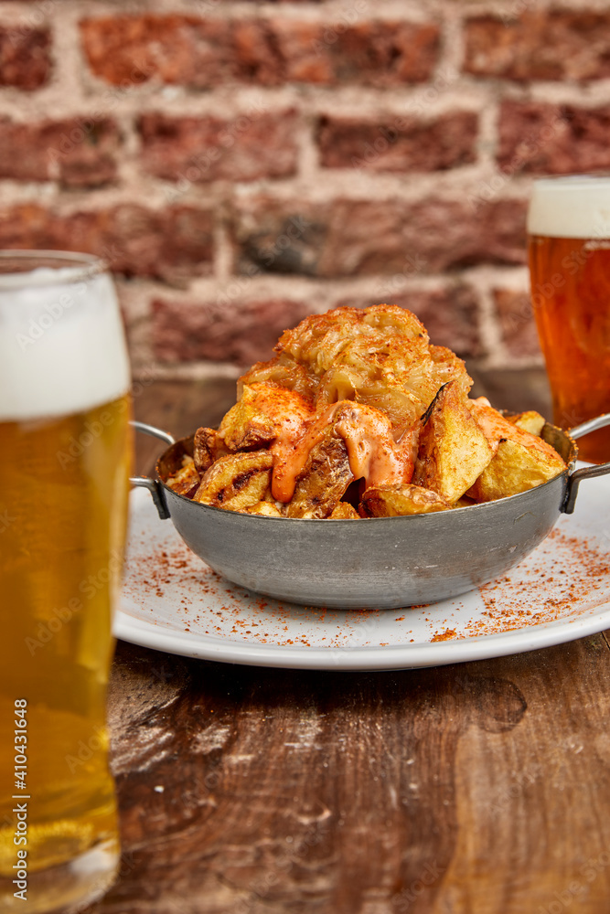 Patatas bravas, Spanish dish with fried potato and a spicy ali oli sauce. Patatas bravas, Spanish dish with fried potato and a spicy ali oli sauce.