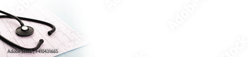 Stethoscope on cardiogram on blue background. Cardiology concept. Panoramic web banner with copy space for your text.