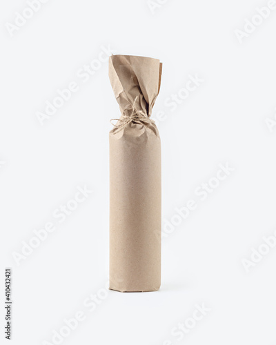 Фотография A bottle of wine wrapped in kraft paper