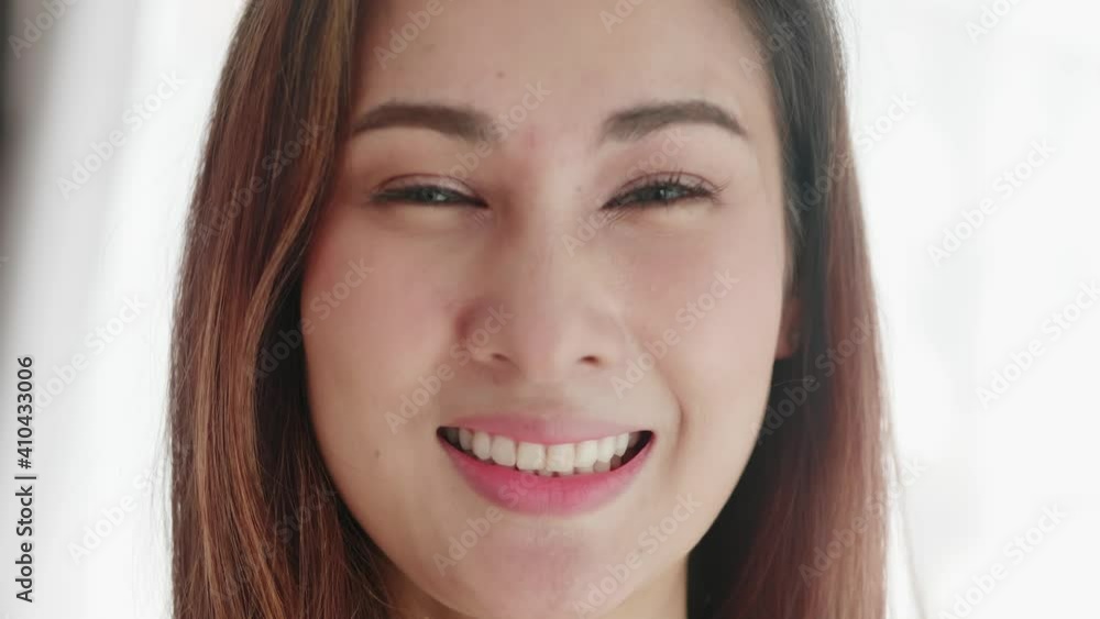 Close up of very beautiful Asian woman smiling in a very cute way and very happy Close up of very beautiful Asian woman smiling in a very cute way and very happy