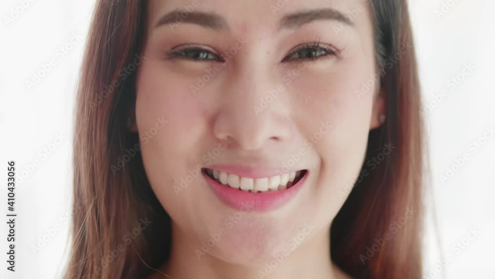Close up of very beautiful Asian woman smiling in a very cute way and very happy Close up of very beautiful Asian woman smiling in a very cute way and very happy