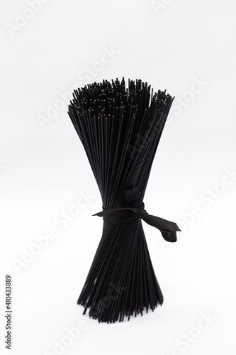 Black pasta on a white background. Black spaghetti © elenavah